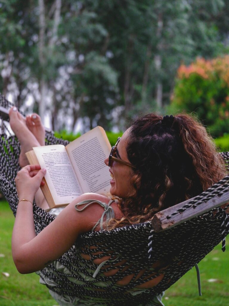 Woman reading and laughing as part of her personal growth goals