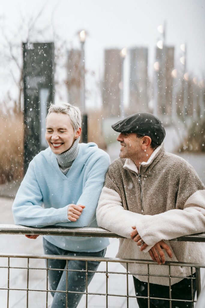 Norwegian couple in the falling snow experiencing a more fulfilling life.