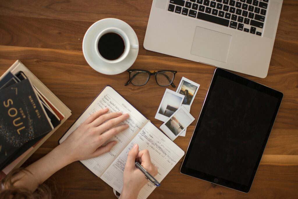 Woman writing in her journal describing photos and giving thanks