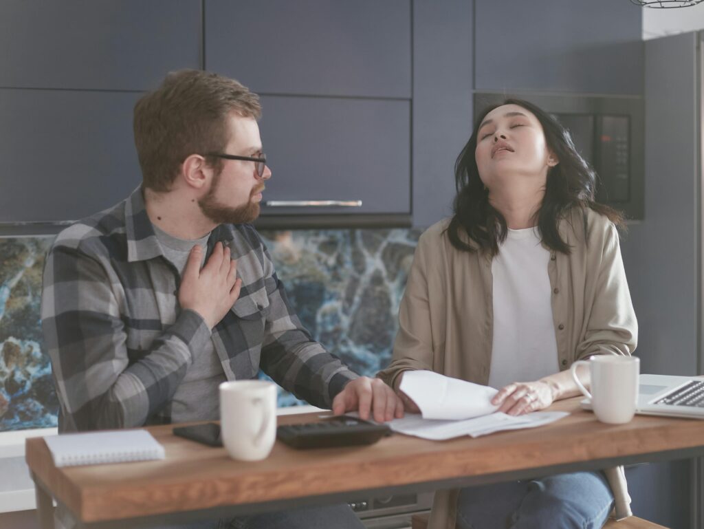 Couple at a table setting goals, frustrated