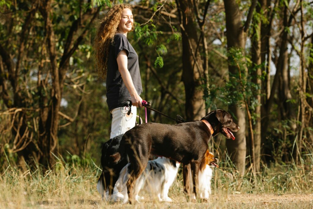 Woman walking a dog outside taking a a break from trying to do it all.